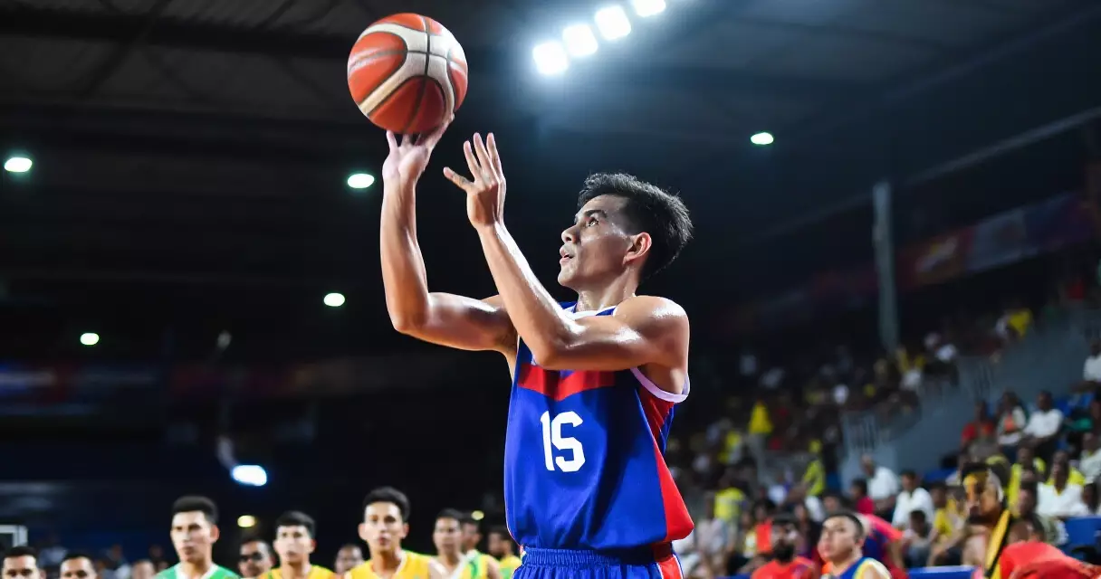Filipino basketball player attempting a shot during a game in an indoor arena