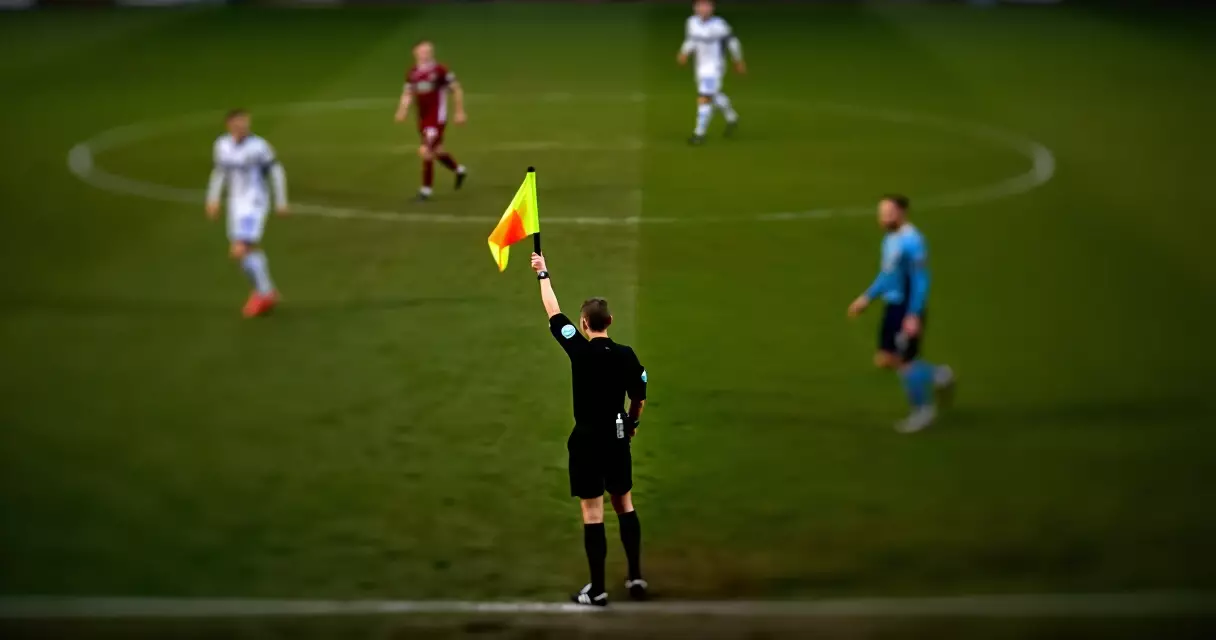 Referee nagwawagayway ng bandila para sa offside sa isang football match